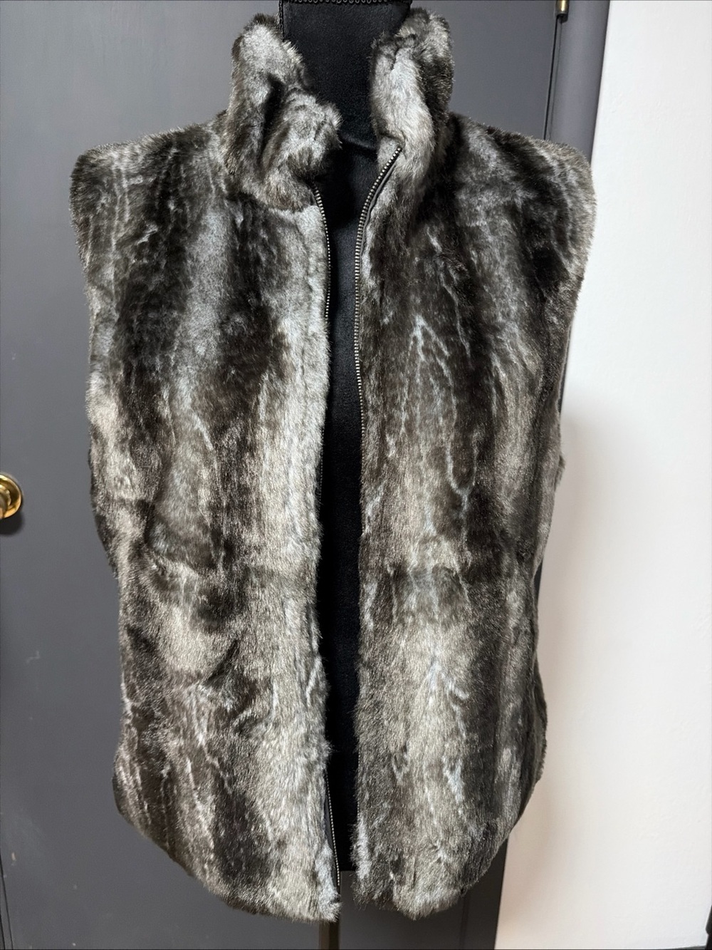 Reversible Blassport gray and black faux fur zip-up vest with a stand-up coll